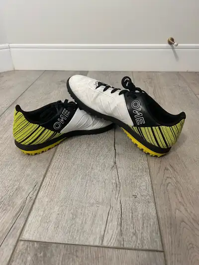 Women’s size 7 soccer cleats. White and black with yellow accents. Artificial turf cleats. $35