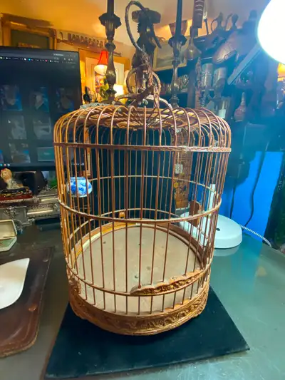 Vintage Bamboo Bird Cage Decorative Carved. Height to top of handle: 25 inches, diameter: 13 inches.