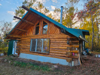 Waterfront cabin on acreage for sale $215,000.