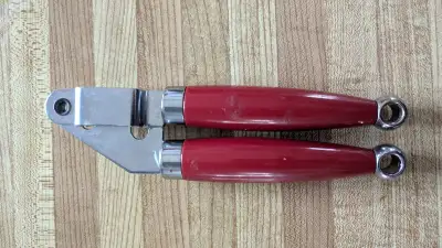 Sturdy solid stainless steel garlic press perfect for crushing garlic and shallots or extracting pul...