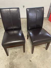 Two brown faux leather chairs