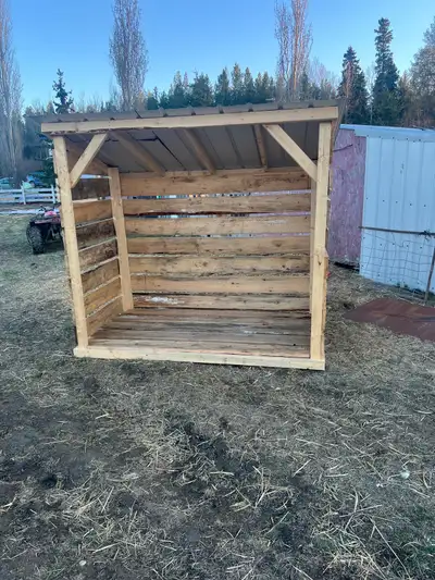 This is a sturdy, used firewood shed, perfect for keeping your firewood dry and organized with dimen...