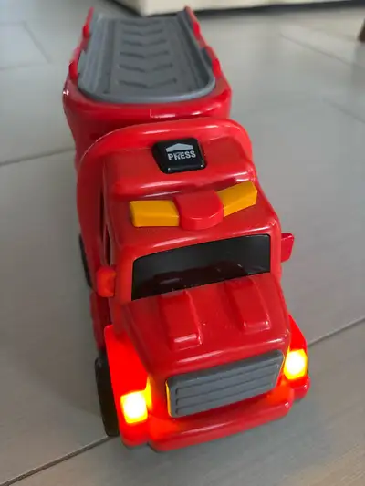 Zoom into action with this vibrant red fire truck, complete with flashing lights for realistic play!...