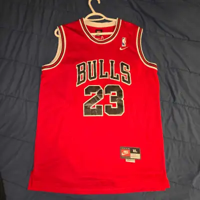 This is a vintage Nike Michael Jordan Chicago Bulls #23 jersey in size XL. The jersey is in used con...