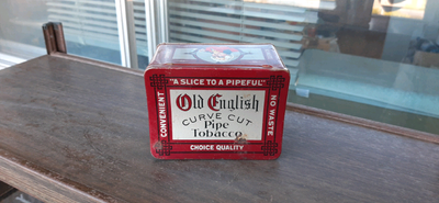 Nice tin with a curved lid. Shows some wear and some rust on the bottom front. Bright graphics and w...