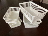 Four plastic containers / baskets