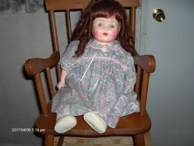 Composition Doll 23".Approx 45 yrs. old. Few paint chips , she has been restored ,new wig & coloring...