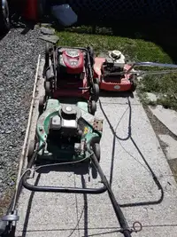 Three old lawn mowers