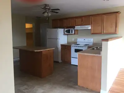 Open concept spacious living room/kitchen,kitchen with lots of cupboards ,including breakfast bar/is...