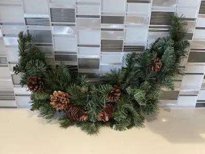 Add a touch of rustic charm to your holiday decor with this quarter crescent wreath, adorned with na...