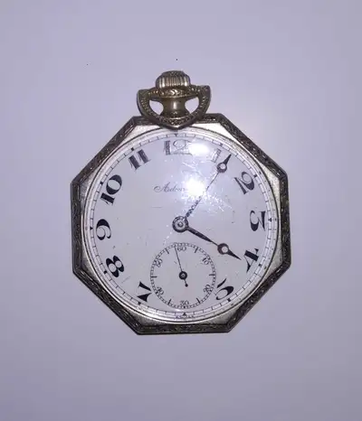 The watch features a distinctive octagonal case with engraved detailing around the bezel, Vintage, t...