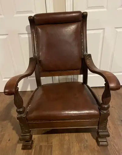 Antique solid wood chair with ornate design. Original leather seat with some damage. Dimensions in p...