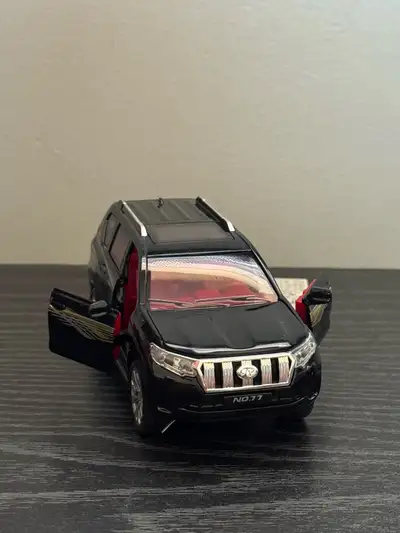 This is a Toyota Prado SUV model car still sealed in the original packaging. It would make a great g...