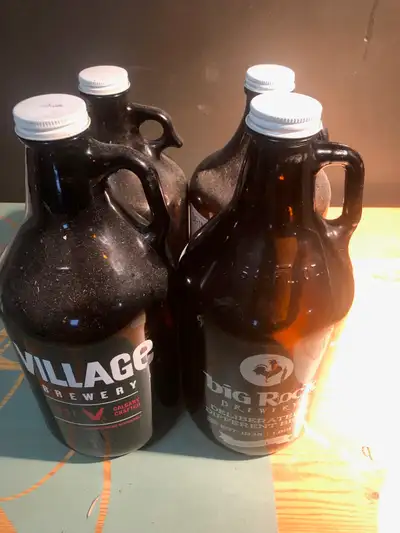 SET OF 4 GROWLERS!!! USED ONCE!!!MISC LOCAL BREWERIES!!! $10 buckaroos for the lot!!!