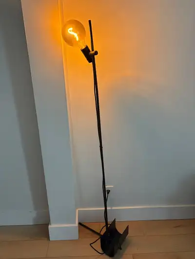 Black, simple and neat floor lamp. Holder for the bulb can rotate/ move up and down on pole. comes w...
