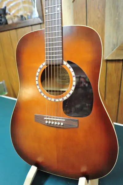 Dreadnought size acoustic guitar. Solid Cedar top. Wild Cherry back and sides. Rosewood fret board a...