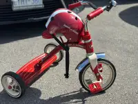 very lightly used Radio flyer tricycle and helmet