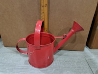 Small red toy watering can