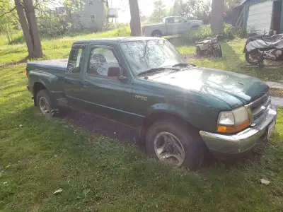 Two green 1999 ford rangers one is a Mazda 1200 cash come get them the truck in the picture very lit...