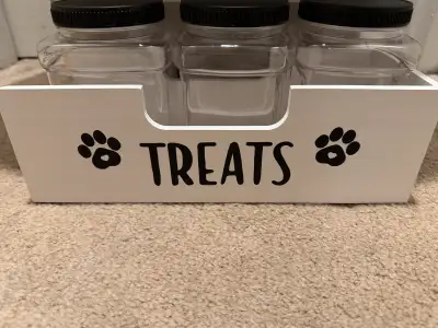 Wooden Dog Treat Container. Includes 3 jars. Unfortunately the left handle broke(shown in pictures)...