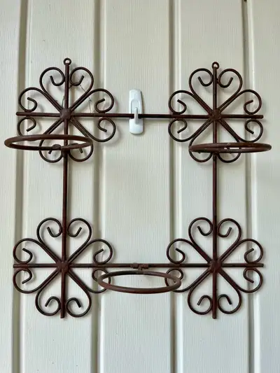 Metal plant holder which is 16” by 16”. It can be mounted on a garden fence or within a patio.