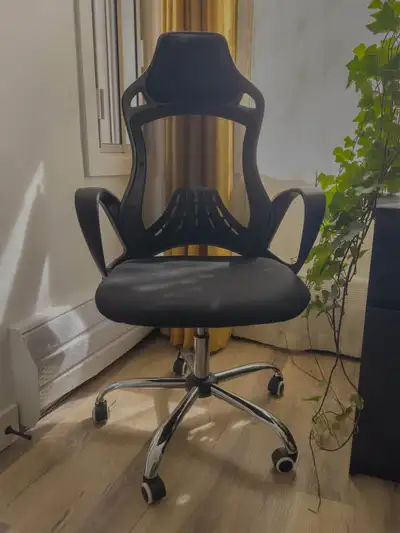 Ergonomic office chair with mesh back, armrests and headrests. Includes height and tilt tension adju...