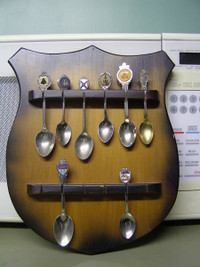 Collection of 8 Spoons and Wall Rack