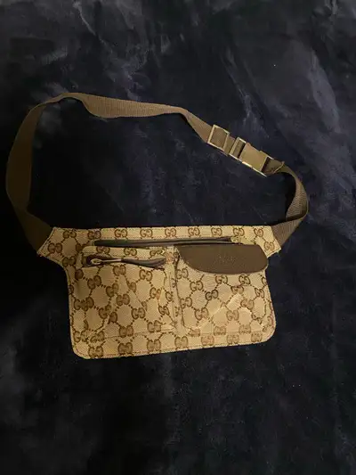 Vintage Gucci fanny pack. Brown canvas with GG logo. Multiple zippered compartments. Adjustable brow...