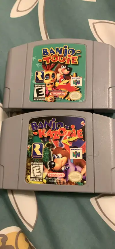 Offering two classic Nintendo 64 games: Banjo-Kazooie and Banjo-Tooie, both in used condition and re...