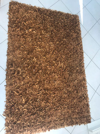 Suede / leather copper coloured strip area rug
