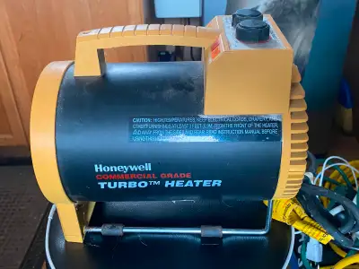 Portable electric heater. Features two heat settings, a fan setting, and adjustable thermostat. Comm...