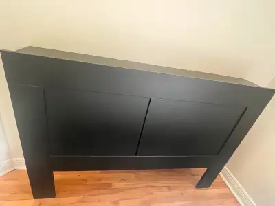 Queen-sized IKEA Brimnes headboard with built-in storage shelving on both sides. One of the side she...