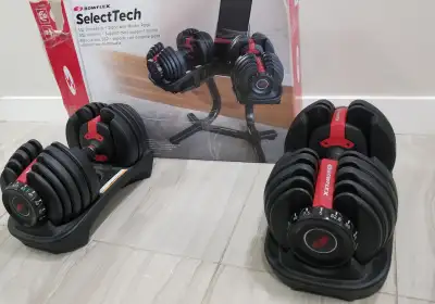 New Bowflex 552 adjustable dumbbells. These dumbbells are packaged and shipped with a strap tied aro...