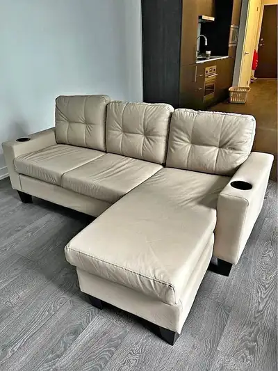 This stylish sectional sofa features a modern design with a chaise lounge and convenient cup holders...