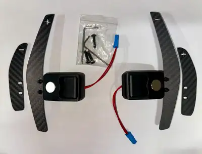 I have a pair of brand new Carbon Fiber magnetic paddles shifter that comes with 2 extra smaller pad...