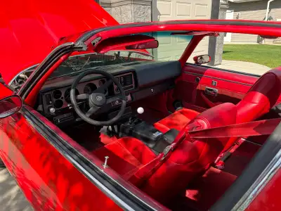 This stunning low kilometre 1981 Chevrolet Camaro Z/28 features a classic red exterior paired with a...
