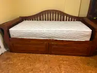 Bed with roll away drawers.