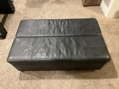 Brown leather sleep trundle bed / Ottoman combo unit. Opens up to a 6 feet bed! Has rolling wheels....
