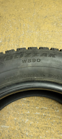 One 195 65 15 Bridgestone Blizzak tire.