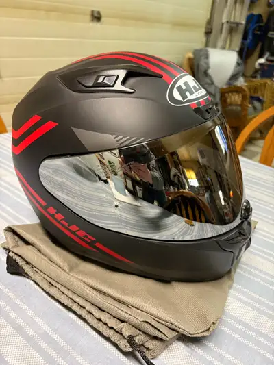 New never worn full face helmet, has tinted shield and comes with helmet bag.