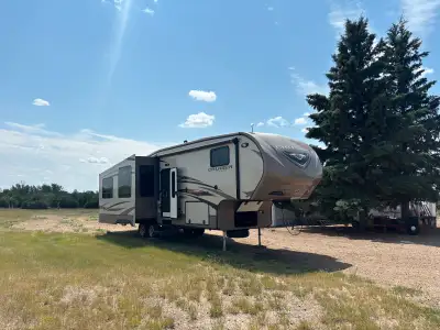 34.5 ft camper trailer with 3 slide outs. 50” television. Fireplace. Two fridges. Trailer has hardly...