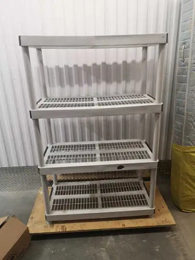 This is a used four-tier white plastic shelving unit, perfect for organizing your garage or basement...