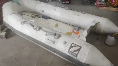 10' long Infaltable boat dinggy. Looks in rough shape but seems to be in good condition. Holds air....