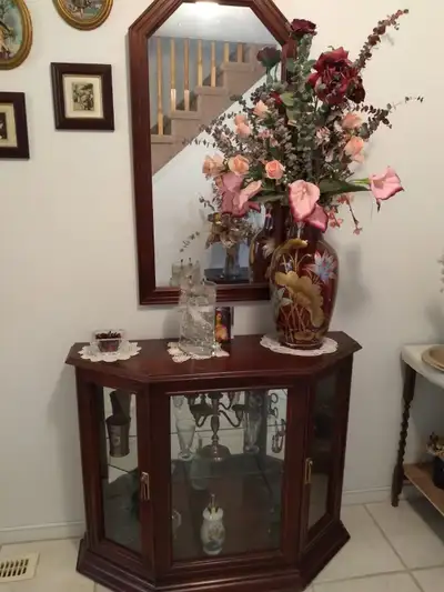 Elegant wooden entrance table and matching mirror set has a rich reddish-brown finish. The cabinet h...