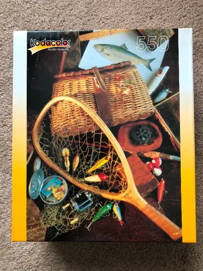 Never opened, box still sealed. Kodacolour “Fishing Gear” picture. Finished puzzle measures 13” x 19...
