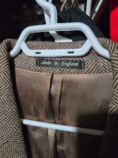 Step into timeless elegance with this full-length men's herringbone overcoat, proudly made in Englan...