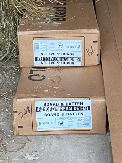 2 full boxes (+ extra pieces) of Iron Ore board and batten siding. 1/2 box of Iron Ore J-trim 2 pans...