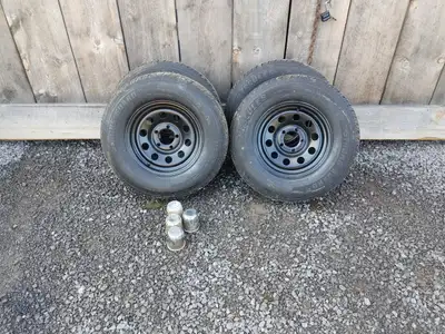 Brand new 14" Trailer tires on Painted rims. Hercules tires , 205/75/14 with center caps. $450 OBO