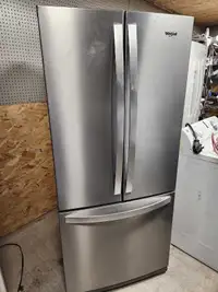 Stainless steel fridge with French doors and freezer on the bott