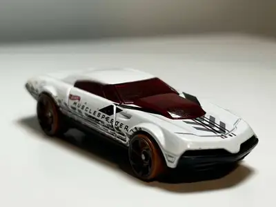 Description of the Car: • The car has a futuristic muscle car design, with a sleek, low-profile body...
